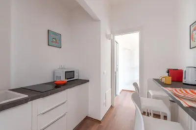 a kitchen with white cabinets and a microwave on a counter at Candelai Apartments by Wonderful Italy in Palermo