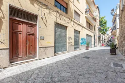 an empty alley with a door on a building at Candelai Apartments by Wonderful Italy in Palermo