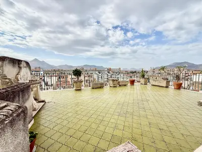 a patio with chairs and a view of a city at La Coccola in Palermo