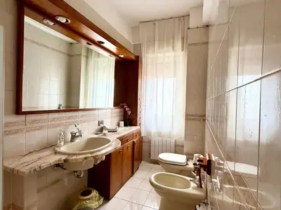 a bathroom with a sink and a toilet and a mirror at La Coccola in Palermo