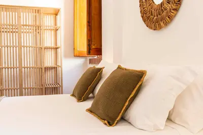 a bedroom with a bed with two pillows on it at Casa D'Acquisto in Santa Flavia