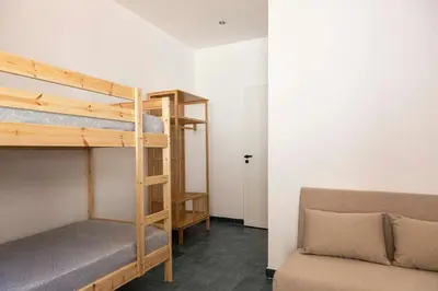 a room with two bunk beds and a couch at Casa D'Acquisto in Santa Flavia