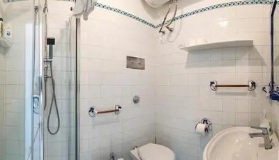 a bathroom with a shower and a toilet and a sink at Casa D'Acquisto in Santa Flavia