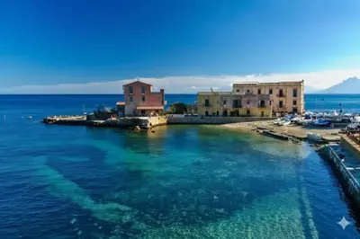 a group of buildings on a body of water at Vicolo a Mare in Porticello