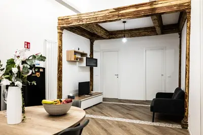 a living room with a table and a mirror at Casa Mazzarino - Exclusive Vucciria Apartment in Palermo