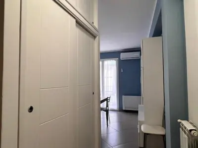 a room with a door and a table and a chair at M'AMA apartment 3 in Ficarazzi