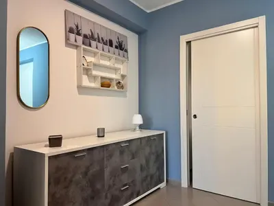 a dressing room with a mirror and a dresser at M'AMA apartment 3 in Ficarazzi
