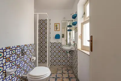 a bathroom with a toilet and a sink at Isola delle Femmine Apartments by Wonderful Italy in Isola delle Femmine