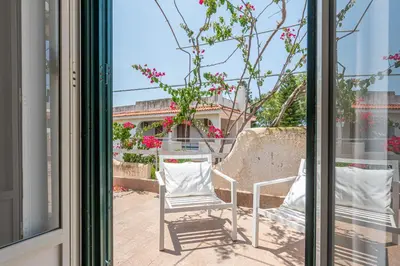 a pair of chairs sitting outside of a window at Isola delle Femmine Apartments by Wonderful Italy in Isola delle Femmine