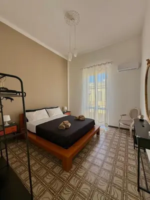 a bedroom with a large bed with two towels on it at Urban Space 49 in Palermo
