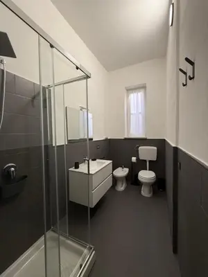 a bathroom with a toilet and a sink and a shower at Urban Space 49 in Palermo