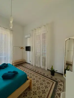 a room with a table and two chairs and a refrigerator at Urban Space 49 in Palermo