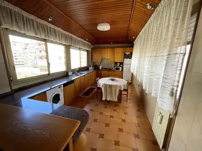 a kitchen with a table in the middle of a room at Palermo Home in Palermo