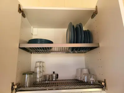 a kitchen with plates and dishes on shelves at Le Case di Sole San Vito Lo Capo in San Vito lo Capo