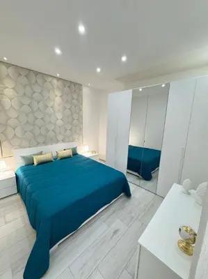 a bedroom with a blue bed in a room at Ciuri D'Amuri in Palermo