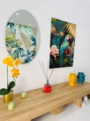 a mirror sitting on top of a wooden table with flowers at Ciuri D'Amuri in Palermo