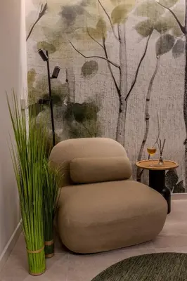 a chair sitting in a room with a wall at Holivù Apartments in Palermo