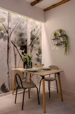 a dining room with a table and two chairs at Holivù Apartments in Palermo