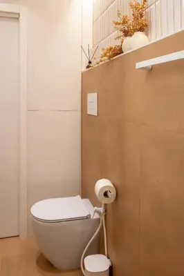 a bathroom with a toilet and a toilet paper roll at Holivù Apartments in Palermo