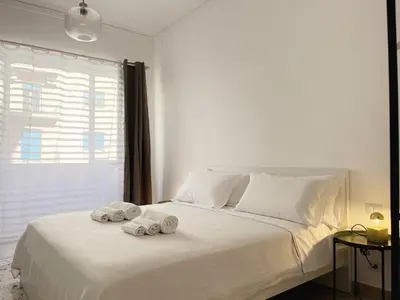 a bedroom with a white bed with towels on it at Palermo central stay in Palermo