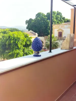 a blue vase sitting on a window sill at Dimora Filangeri in Santa Flavia