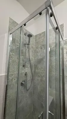 a shower with a glass door in a bathroom at Dimora Filangeri in Santa Flavia