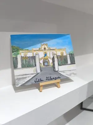 a painting of a building on top of a table at Dimora Filangeri in Santa Flavia