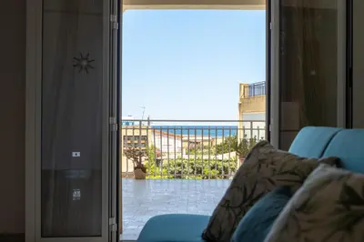a sliding glass door with a view of a patio at I Piani Apartment in Trabia