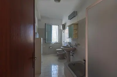 a bathroom with a sink and a toilet and a sink at I Piani Apartment in Trabia