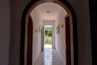 an archway leading to a hallway with an open door at I Piani Apartment in Trabia