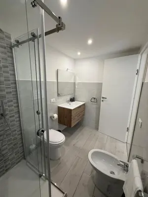 a bathroom with a toilet and a sink and a shower at Al canto del sole in Palermo