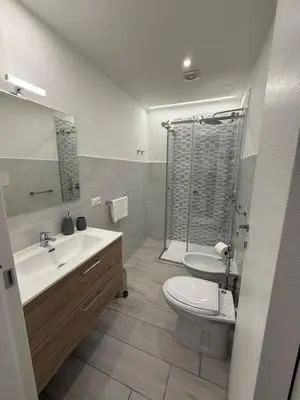 a bathroom with a toilet and a sink and a shower at Al canto del sole in Palermo