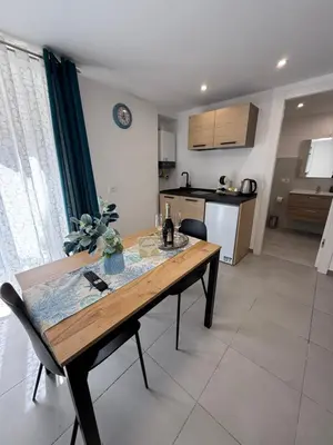 a kitchen with a wooden table and a dining room at Al canto del sole in Palermo
