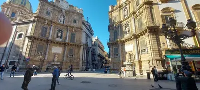 a group of people standing in front of buildings at Al canto del sole in Palermo