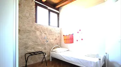 a small room with a bed and a window at Visitsicilia Villa Cialoma in Scopello