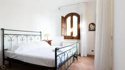 a bedroom with a black bed and a mirror at Visitsicilia Villa Cialoma in Scopello