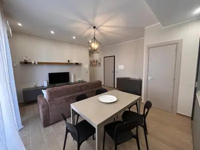 a living room with a table and a couch at Notarbartolo Casa Centrale in Palermo