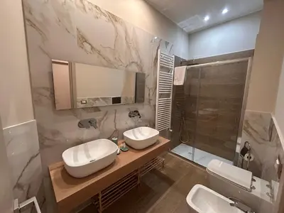 a bathroom with two sinks and a shower at Notarbartolo Casa Centrale in Palermo