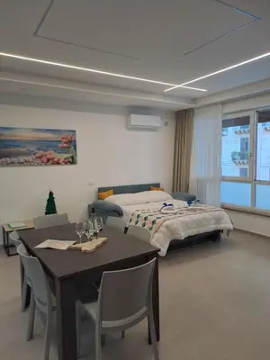 a bedroom with a bed and a table and chairs at Al Centro di Palermo - Casa Bertolino in Palermo