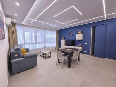 a living room with a table and a blue wall at Al Centro di Palermo - Casa Bertolino in Palermo