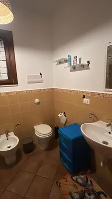 a bathroom with a toilet and a sink at La Casa di Cat in Palermo