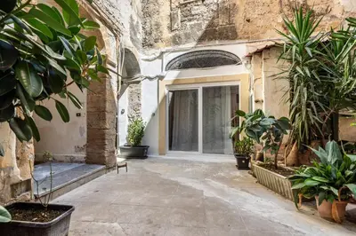 an entrance to a building with potted plants at Loft San Basilio in Palermo