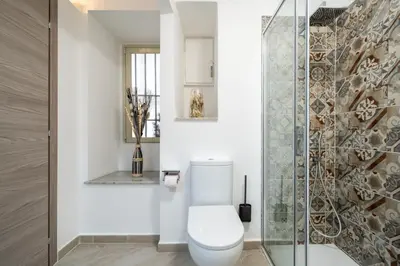 a bathroom with a toilet and a glass shower at Loft San Basilio in Palermo