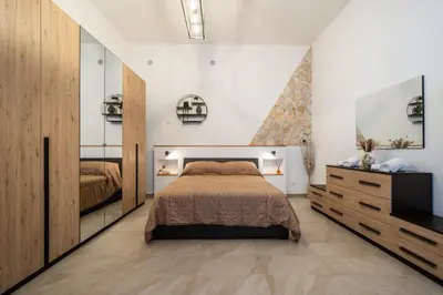 a bedroom with a large bed and a television at Loft San Basilio in Palermo