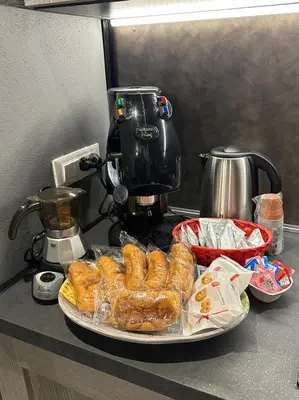 a plate of pastries on a counter with a coffee maker at Casa Luma Palermo in Palermo