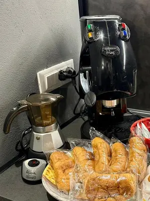a pile of croissants on a counter next to a coffee maker at Casa Luma Palermo in Palermo