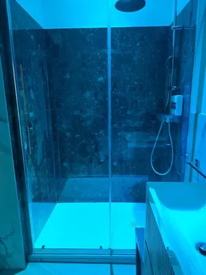 a bathroom with a shower with blue lights at La Mantia Luxury Rooms in Palermo