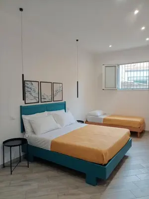 a bedroom with two beds in a room at Blu di Sicilia in Palermo