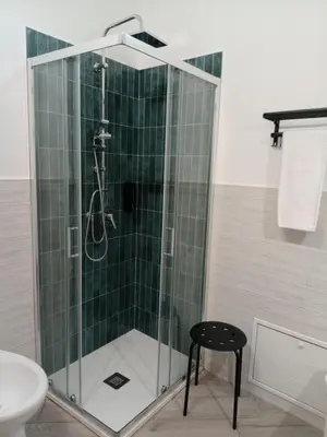 a shower with a glass enclosure in a bathroom at Blu di Sicilia in Palermo
