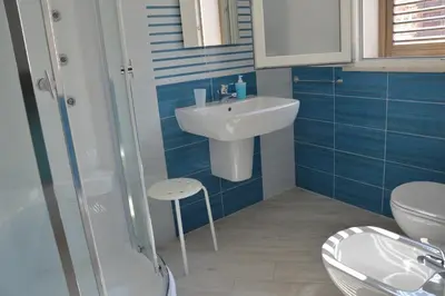 a bathroom with a sink and a toilet at Stanze del Mare in Balestrate